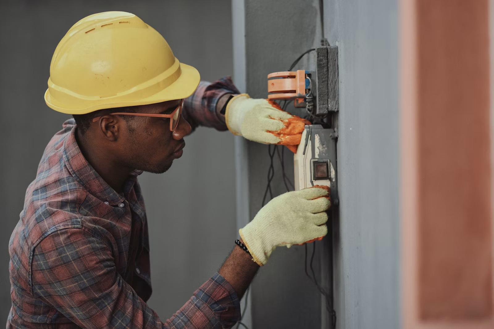 Electrician working on a wall panel